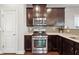 Kitchen with dark cabinets, granite counters, and gas range at 1043 Belmont Commons Dr, Smyrna, GA 30080