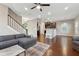 Spacious living room with hardwood floors, fireplace, and gray sectional sofa at 1043 Belmont Commons Dr, Smyrna, GA 30080