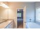 Bathroom with granite countertop, bathtub and view into bedroom at 115 Oakdale Way, Temple, GA 30179