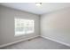 Bright bedroom with carpet flooring and a large window at 115 Oakdale Way, Temple, GA 30179