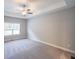 Spacious bedroom with ceiling fan and plush carpeting at 115 Oakdale Way, Temple, GA 30179