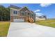 Two-story house with stone accents, large driveway and a green lawn at 115 Oakdale Way, Temple, GA 30179