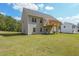 Tan house exterior with deck and grassy backyard at 115 Oakdale Way, Temple, GA 30179