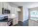 Modern kitchen with stainless steel appliances and white cabinets at 115 Oakdale Way, Temple, GA 30179