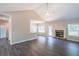 Open living room with a stone fireplace and kitchen island at 115 Oakdale Way, Temple, GA 30179