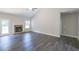 Spacious living room with stone fireplace and vinyl flooring at 115 Oakdale Way, Temple, GA 30179