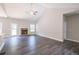 Spacious living room featuring a stone fireplace and vinyl plank flooring at 115 Oakdale Way, Temple, GA 30179