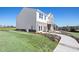 Side view of a two-story house with white and brick exterior and landscaped yard at 165 Delilah St, Mcdonough, GA 30252