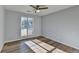 Well-lit bedroom with wood-look floors and large window at 175 Paris Dr, Lawrenceville, GA 30043