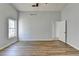 Bright bedroom with hardwood floors, one window and an open door to a hallway at 175 Paris Dr, Lawrenceville, GA 30043