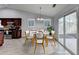 Kitchen and dining area combo with tiled floor, modern kitchen, and sliding door to backyard at 175 Paris Dr, Lawrenceville, GA 30043