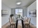 Bright dining room with glass table and six chairs, hardwood floors, and large window at 175 Paris Dr, Lawrenceville, GA 30043