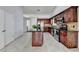 Kitchen with dark wood cabinets, granite island and stainless steel appliances at 175 Paris Dr, Lawrenceville, GA 30043