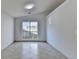 Simple living room with tile flooring and a large window at 175 Paris Dr, Lawrenceville, GA 30043