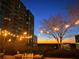 Evening city view from patio with string lights and grill at 250 Pharr Ne Rd # 602, Atlanta, GA 30305