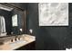 Stylish powder room with dark wallpaper and granite vanity at 580 Grimsby Ct, Suwanee, GA 30024