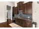 Modern kitchen with dark wood cabinets and granite countertops at 580 Grimsby Ct, Suwanee, GA 30024