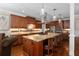 Gourmet kitchen with granite island, stainless steel appliances, and wood cabinets at 580 Grimsby Ct, Suwanee, GA 30024