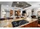 Kitchen island with cooktop, granite countertop, and views into the living room at 580 Grimsby Ct, Suwanee, GA 30024