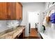 Laundry room with built-in cabinets, granite countertop, and bench at 580 Grimsby Ct, Suwanee, GA 30024