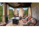 Relaxing screened porch with wicker furniture and fire pit at 580 Grimsby Ct, Suwanee, GA 30024