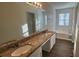 Bathroom boasts double sinks, granite counters, and a tub at 710 Ridge Way, Lithonia, GA 30058