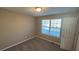 Bright bedroom with neutral walls and carpet at 710 Ridge Way, Lithonia, GA 30058