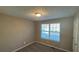 Bright bedroom with neutral walls and carpet at 710 Ridge Way, Lithonia, GA 30058