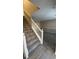 Staircase with simple white railing leading to the upper level at 710 Ridge Way, Lithonia, GA 30058