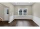 Dining room with dark hardwood floors and white wainscoting at 116 Carriage Oak Dr, Villa Rica, GA 30180