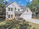 Two-story house with gray siding, stone accents, and a two-car garage at 116 Carriage Oak Dr, Villa Rica, GA 30180