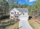 Two-story house with gray siding, stone accents, and a two-car garage at 116 Carriage Oak Dr, Villa Rica, GA 30180