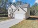 Two-story house with gray siding, stone accents, and a two-car garage at 116 Carriage Oak Dr, Villa Rica, GA 30180