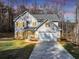 Two-story house with gray siding, stone accents, and a two-car garage at 116 Carriage Oak Dr, Villa Rica, GA 30180