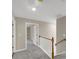 Upstairs hallway with gray carpeting and access to bedrooms at 116 Carriage Oak Dr, Villa Rica, GA 30180