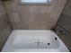 Clean bathroom with a bathtub and neutral tile surround at 2531 Ridgecrest Nw Dr, Kennesaw, GA 30152