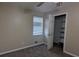 Well-lit bedroom with neutral walls, carpet flooring, and built-in shelving at 2531 Ridgecrest Nw Dr, Kennesaw, GA 30152