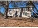 Tan two-story house with red shutters and tree-lined yard at 2531 Ridgecrest Nw Dr, Kennesaw, GA 30152