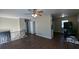 Bright living room featuring a ceiling fan and dark wood-look flooring at 2531 Ridgecrest Nw Dr, Kennesaw, GA 30152