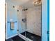 Updated bathroom with a walk-in shower and marble tile at 461 Trabert Nw Ave, Atlanta, GA 30309