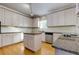 Modern kitchen with white cabinets, granite counters, and island at 991 Greenwood Ne Ave, Atlanta, GA 30306