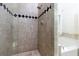 Shower with beige tile and black and white accents at 991 Greenwood Ne Ave, Atlanta, GA 30306