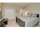 Spacious bedroom with a king-size bed, double doors to closet, and neutral decor at 209 Candice Ct, Hampton, GA 30228