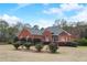 Brick home with gray roof, landscaping, and a spacious yard at 209 Candice Ct, Hampton, GA 30228