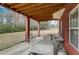 Covered patio with brick columns, stone table, and bench at 209 Candice Ct, Hampton, GA 30228