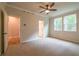 Bedroom featuring neutral carpet, ceiling fan, and two windows allowing natural light at 307 Willam Gossett Dr, Canton, GA 30114
