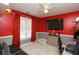 Red-themed bedroom with large TV and gaming setup at 190 Country Club Dr, Hiram, GA 30141