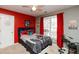 Bedroom with red accent wall, Spiderman bedding, and window seating at 190 Country Club Dr, Hiram, GA 30141