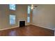 Two-story living room with hardwood floors and fireplace at 4489 Carriage Park Dr, Lithonia, GA 30038