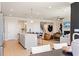 Bright living area featuring hardwood floors, an open staircase, and a view to the kitchen at 1446 Auburn Glen Rd, Dacula, GA 30019